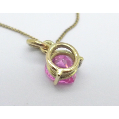 1008 - A 9ct gold pendant set with a heart shaped pink stone and a 9ct gold chain, 6.5g