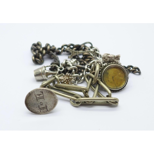 1020 - A silver Albert and a silver charm bracelet, 70g, and one other chain with seal fob