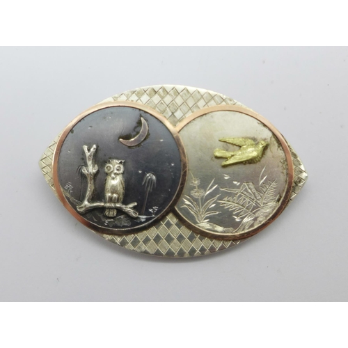 1028 - A Victorian silver aesthetic night and day brooch with owl night scene and gold detail, width 45mm