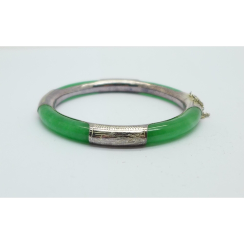 1035 - A silver and jade bangle