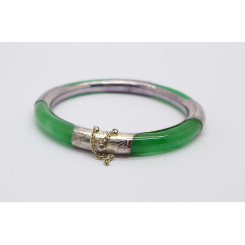 1035 - A silver and jade bangle