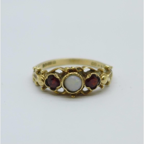 1076 - A 9ct gold, opal and garnet ring, 2.3g, O