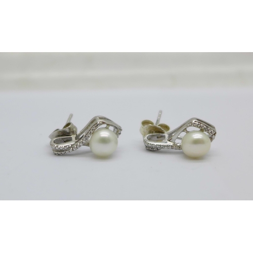 1120 - A pair of silver, diamond and pearl earrings