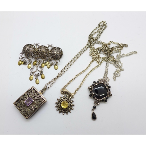 1125 - Three silver pendants and chains and a silver brooch