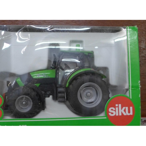 626 - Five model tractors, Siku, Ertl and Britains, boxed