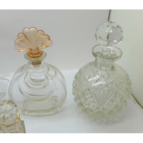 659 - A glass claret jug with plated top and three scent bottles