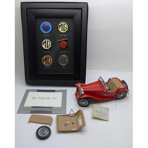 670 - A Franklin Mint  MG TC 1948 model car, a/f, and a set of MG badges