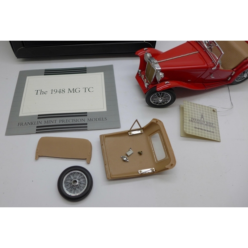 670 - A Franklin Mint  MG TC 1948 model car, a/f, and a set of MG badges