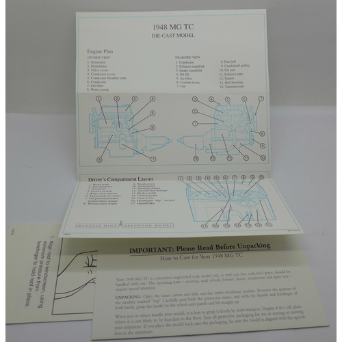 670 - A Franklin Mint  MG TC 1948 model car, a/f, and a set of MG badges
