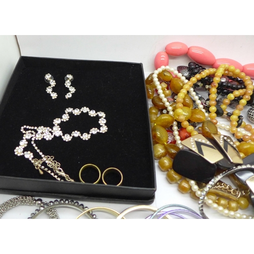 676 - A box of costume jewellery including bangles