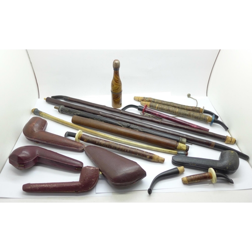 679 - A novelty pipe/champagne bottle, cherrywood and other pipe stems and pipe cases