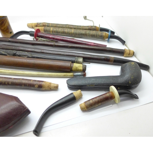 679 - A novelty pipe/champagne bottle, cherrywood and other pipe stems and pipe cases