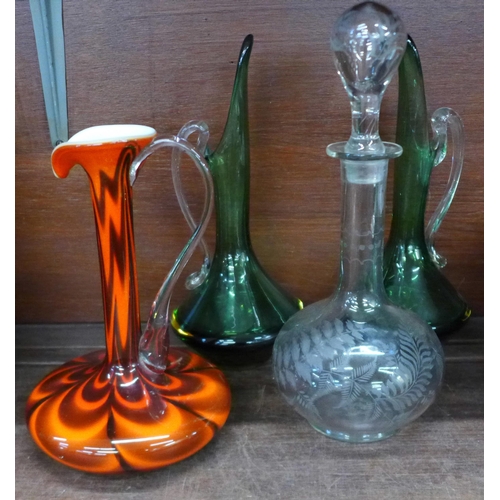 713 - A pair of green glass vases, one other vase and a decanter