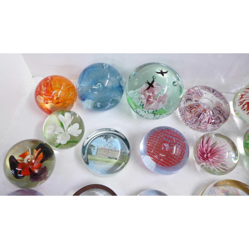 715 - A collection of eighteen glass paperweights