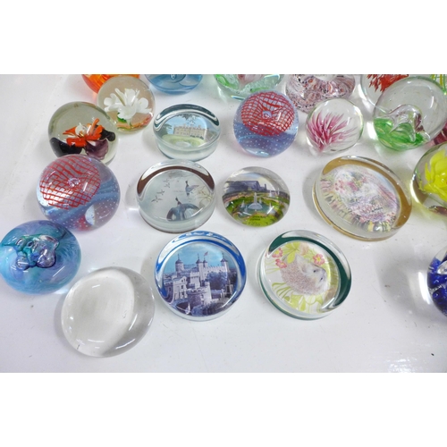 715 - A collection of eighteen glass paperweights