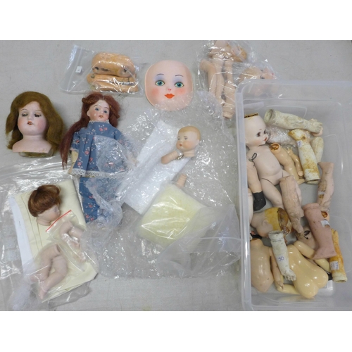 734 - A small box of mixed bisque and composition doll body parts including a German E&S head