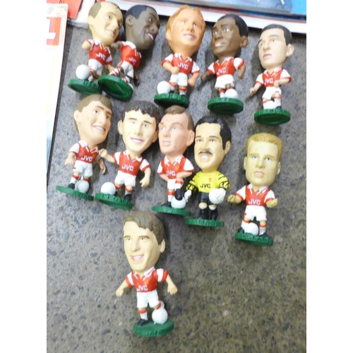 735 - Football programmes; Arsenal home and away programmes (34 no.) and eleven figurines of Arsenal Invin... 