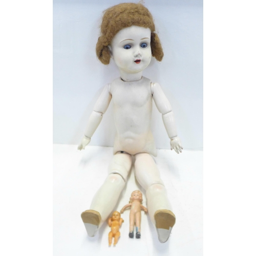 799 - A composite doll with porcelain head and two smaller dolls