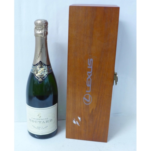 818 - A bottle of champagne, Moutard Brut Grande Cuvee, in a presentation box marked Lexus