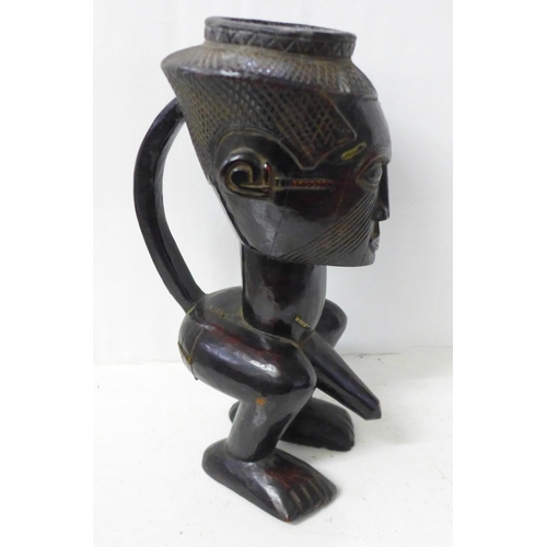 821 - A carved African Kuba palm wine cup