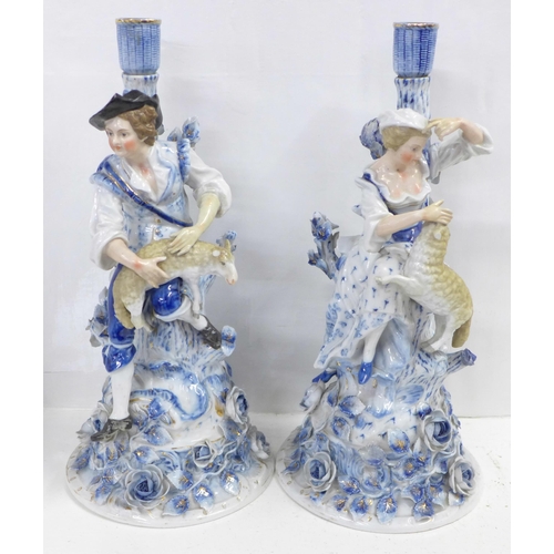 832 - A pair of blue porcelain candlesticks, shepherd and shepherdess, some a/f