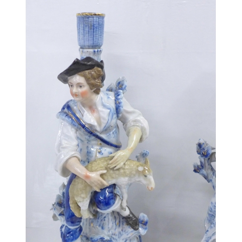 832 - A pair of blue porcelain candlesticks, shepherd and shepherdess, some a/f