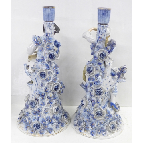 832 - A pair of blue porcelain candlesticks, shepherd and shepherdess, some a/f