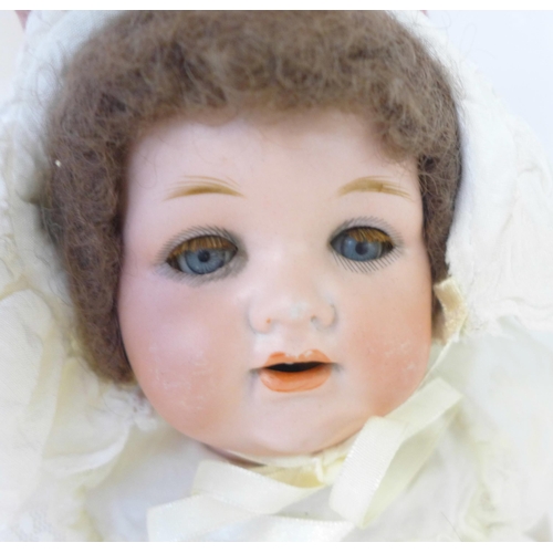 833 - A German Armand Marseille bisque head doll with blue sleep eyes, 990 O ½ M identification mark, circ... 