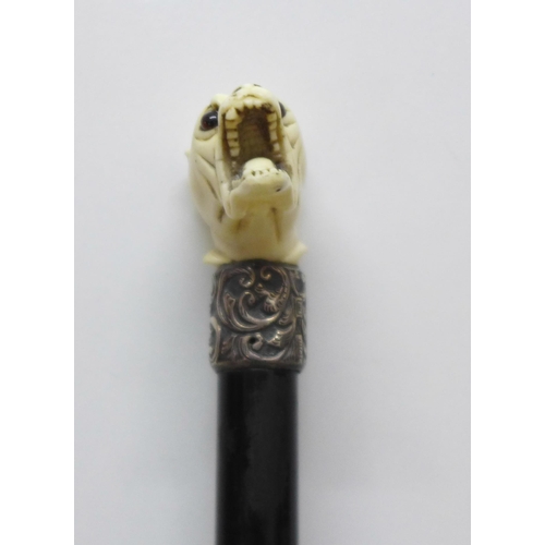 850 - A swagger stick with carved dogs head top, some a/f on dogs head