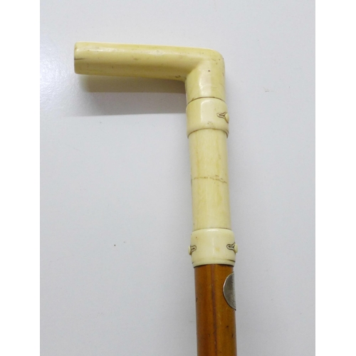 852 - A 19th Century gentleman's walking stick, the L-shaped ivory handle carved with faux buttoned straps... 