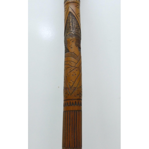 854 - A bamboo walking stick with Japanese carvings, Geisha girls, 89cm