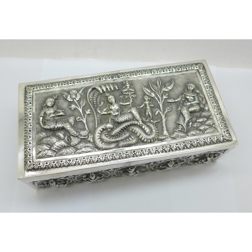 878 - An Eastern white metal cigarette box, total weight 395g, width 18cm, a/f, dented