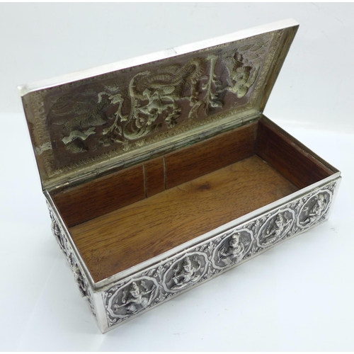 878 - An Eastern white metal cigarette box, total weight 395g, width 18cm, a/f, dented