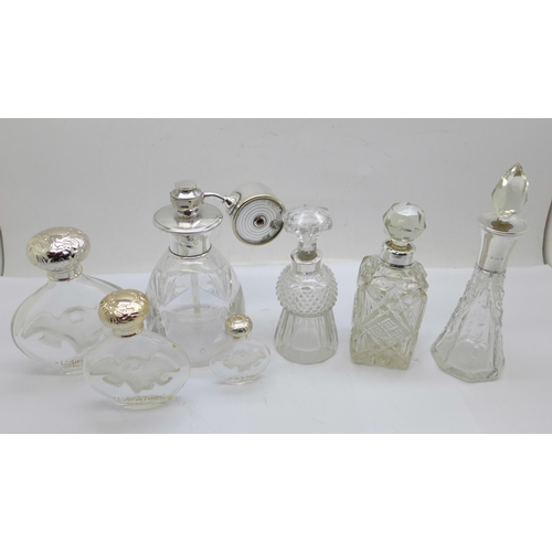 884 - Three silver mounted glass scent bottles including one thistle shaped and hallmarked Birmingham 1900... 