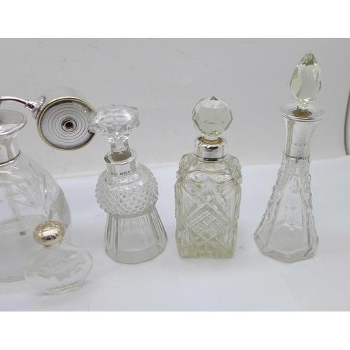 884 - Three silver mounted glass scent bottles including one thistle shaped and hallmarked Birmingham 1900... 