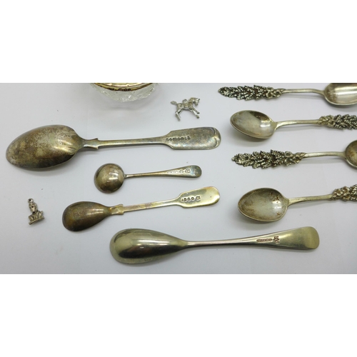 902 - A silver rimmed glass salt, a set of five white metal spoons, four plated spoons, etc.