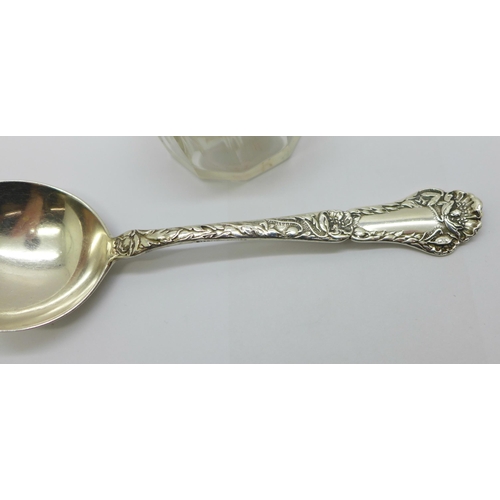 905 - A silver topped glass pot and a silver spoon with import mark, 26g of silver