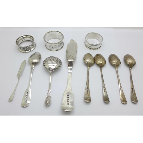 907 - A collection of silver including a George IV silver spreader and two napkin rings, etc., a plated na... 