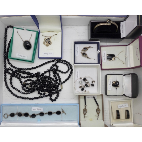 939 - A collection of silver and silver mounted jewellery and four faceted black bead necklaces