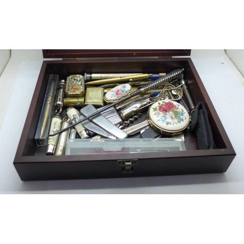 947 - A wooden box with contents, penknives, pens, an Acme City whistle, etc.