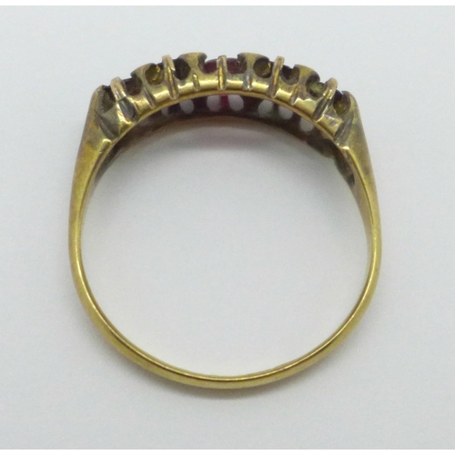 951 - An 18ct gold five stone ring, set with four garnets and replacement red centre stone, Birmingham 190... 