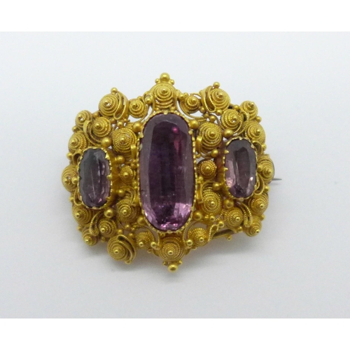 966 - A Victorian yellow metal and three stone amethyst brooch, 10.4g, (tests as 18ct gold), a/f, centre s... 