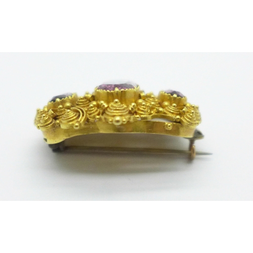 966 - A Victorian yellow metal and three stone amethyst brooch, 10.4g, (tests as 18ct gold), a/f, centre s... 