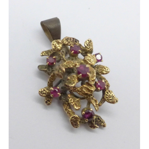 969 - A yellow metal and red stone pendant, (tests as 9ct gold), 6g