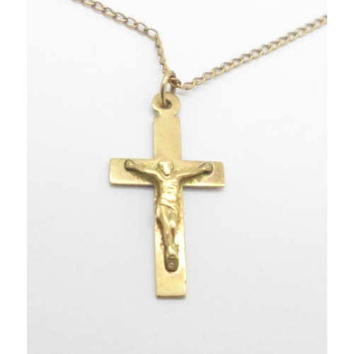 974 - A 9ct gold crucifix on a yellow metal chain, 2.2g, (tests as 9ct)