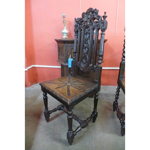 210 - Two Victorian Jacobean Revival carved oak hall chairs