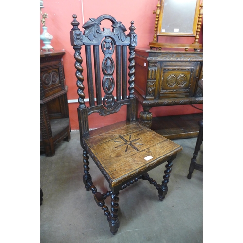 210 - Two Victorian Jacobean Revival carved oak hall chairs