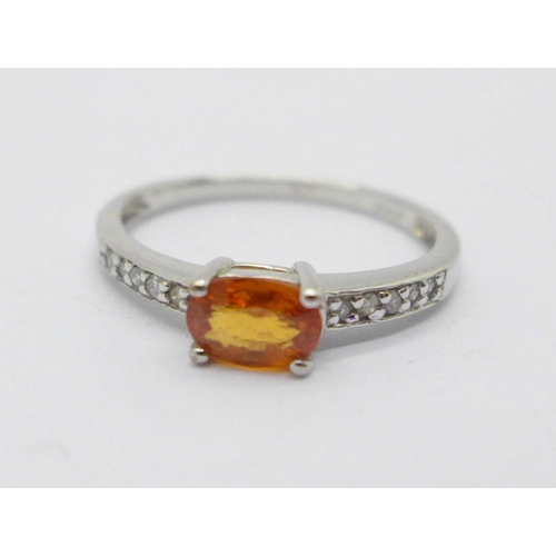 987 - A 9ct white gold ring set with a fire opal and diamond shoulders, 1.8g, M