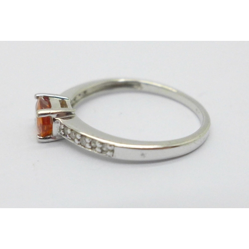 987 - A 9ct white gold ring set with a fire opal and diamond shoulders, 1.8g, M