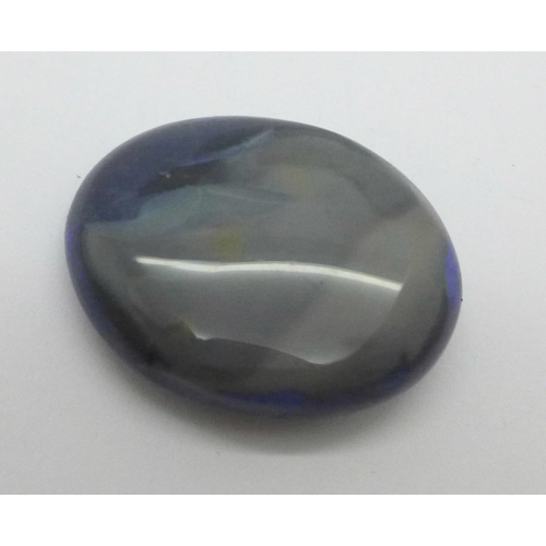 990 - An unmounted black opal, over 47 carats, 26mm x 32mm